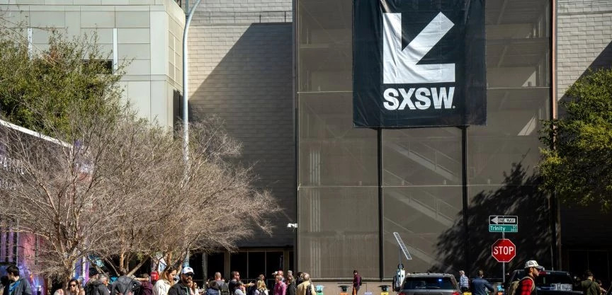 Busy downtown Austin street with SXSW banner