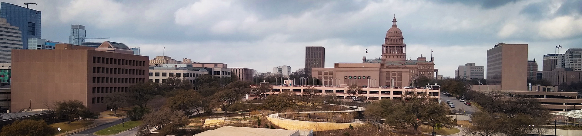 Aerial view of the 1215 Red River and 606 East 6th Street Redevelopment site, with a skyline including the Texas Capitol.