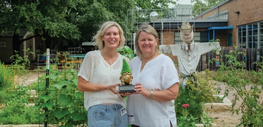 FiG Winner Abbey Seidensticker poses with staff member Mary K. Priddy in the Zilker Elementary garden with the coveted Golden Gnome trophy.