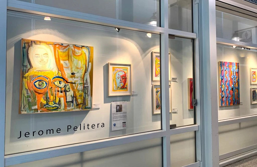 Colorful figurative art by Jerome Pelitera on the wall at Austin-Bergstrom International Airport