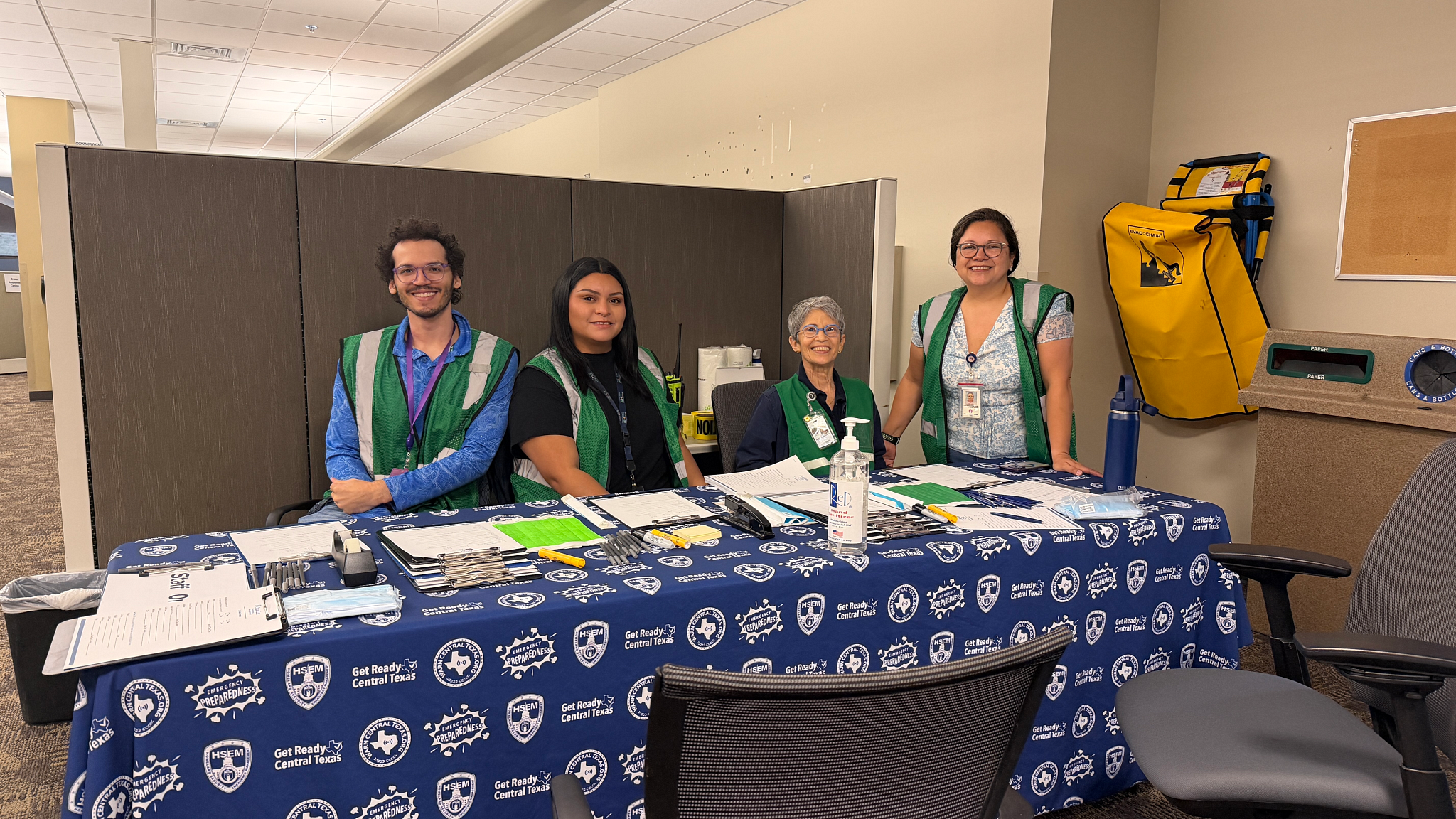 A photo showing Austin Public Health Public Health and Emergency Preparedness program staff behind a table at the Victim Assistance Center