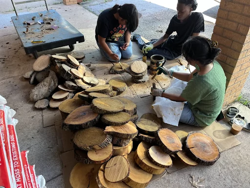 AISD representatives prepare tree cookies for AISD Nature kits. 