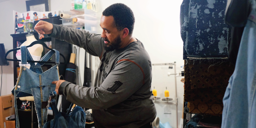 Billy points out details on a recycled denim top, made from a pair of pockets.