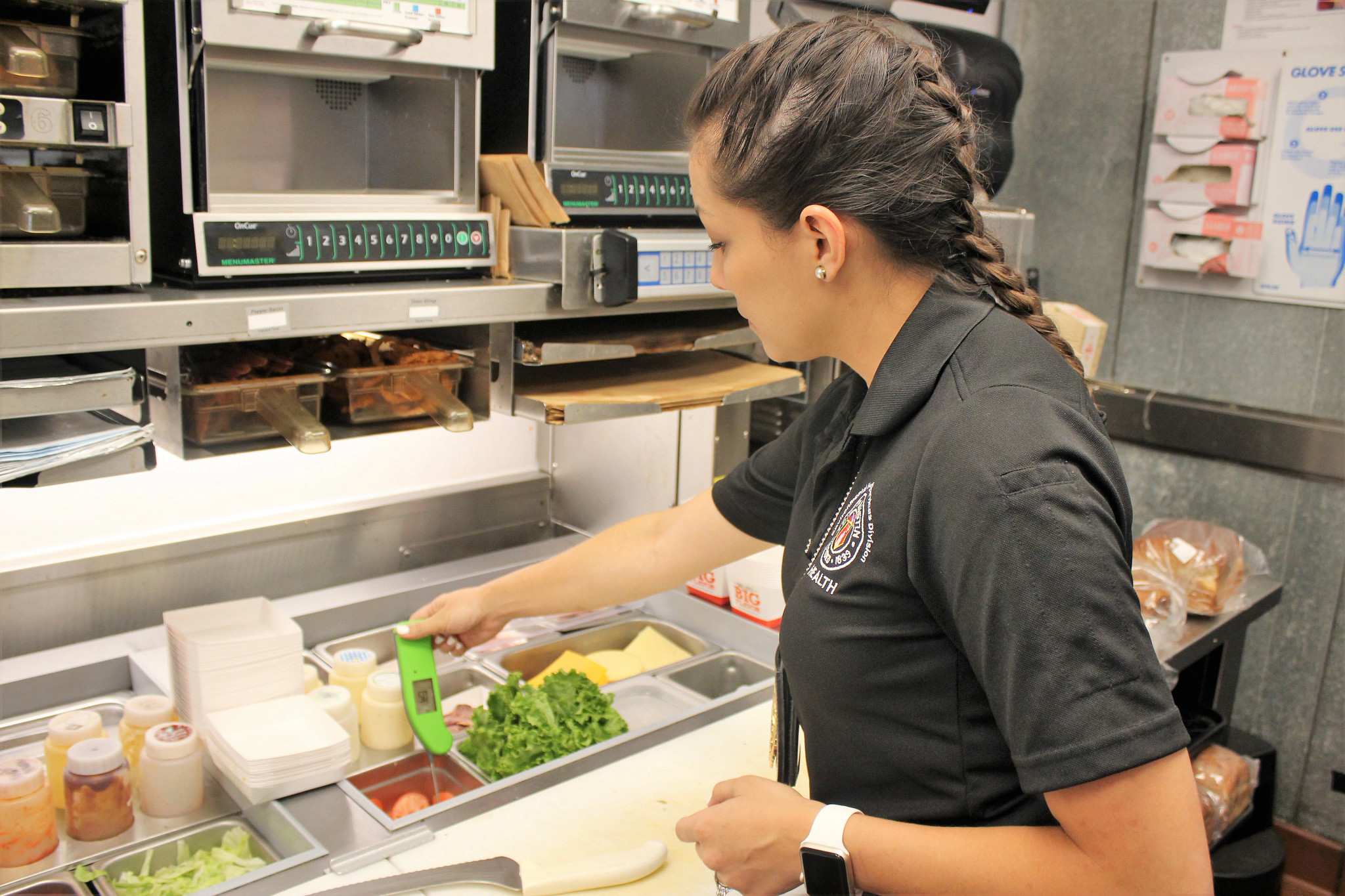 A health inspector checks the temperature of food