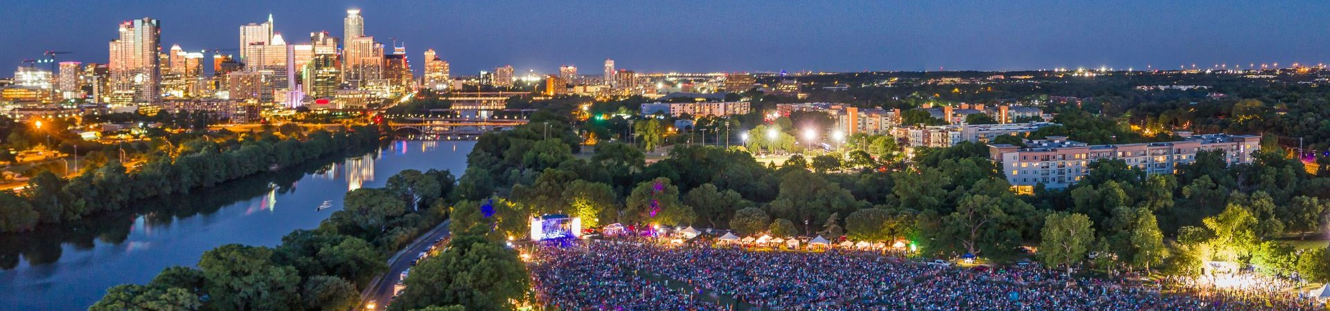 Banner with an overhead view of Austin City Limits Music Festival in Zilker Park with Austin downtown in the background.