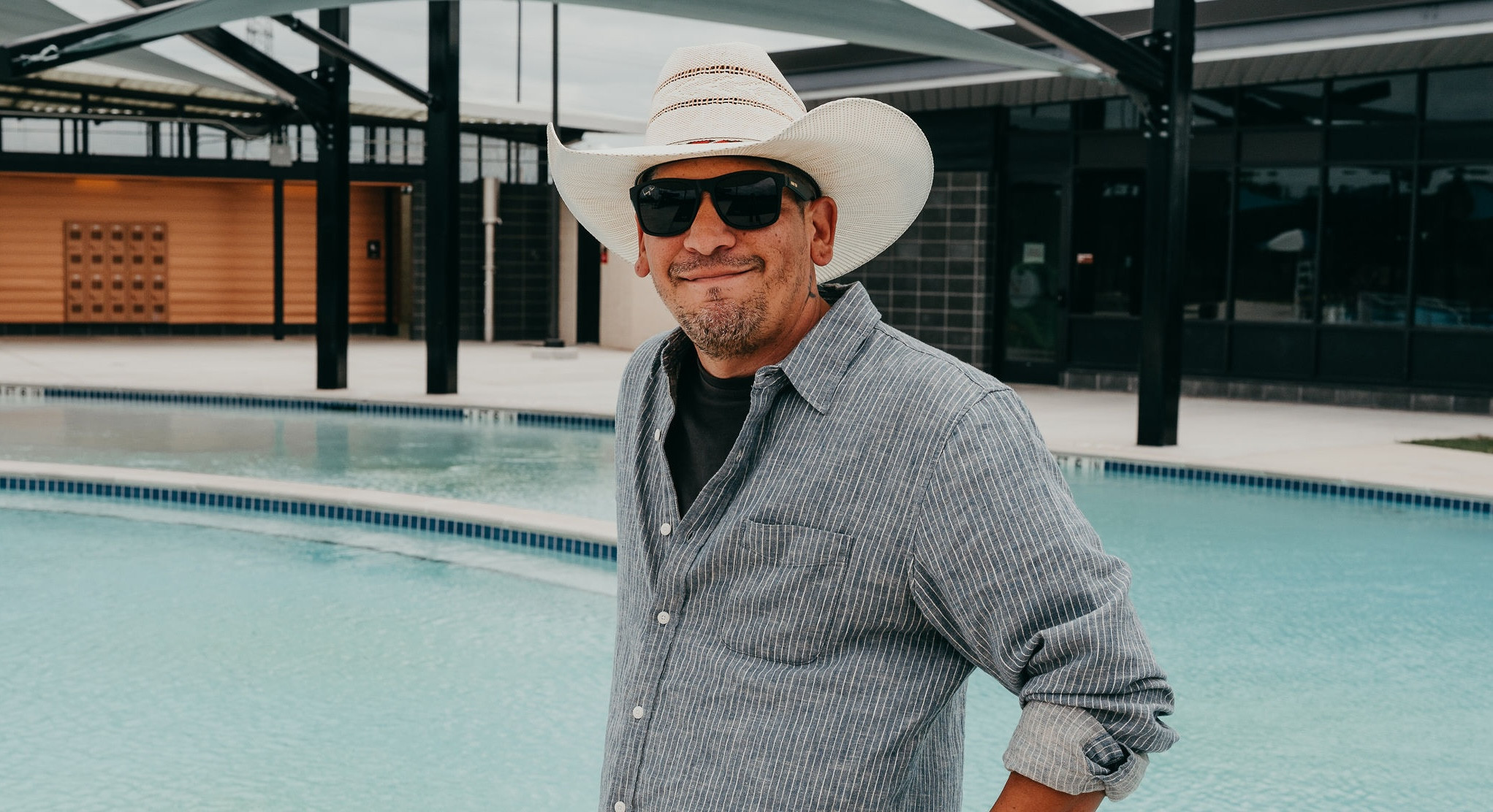 Staff member standing in front of a pool