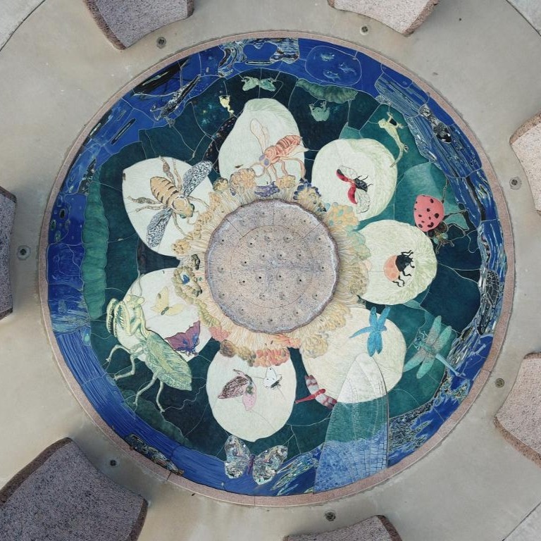 Overhead view of a large mosaic of a lotus with animals on it