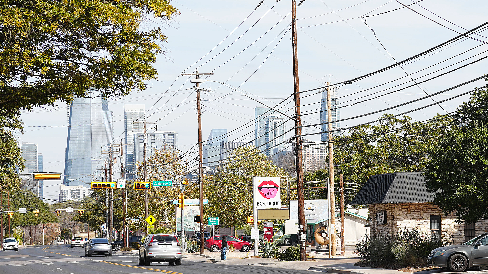 businesses lining the east side of south first street with downtown Austin in the background