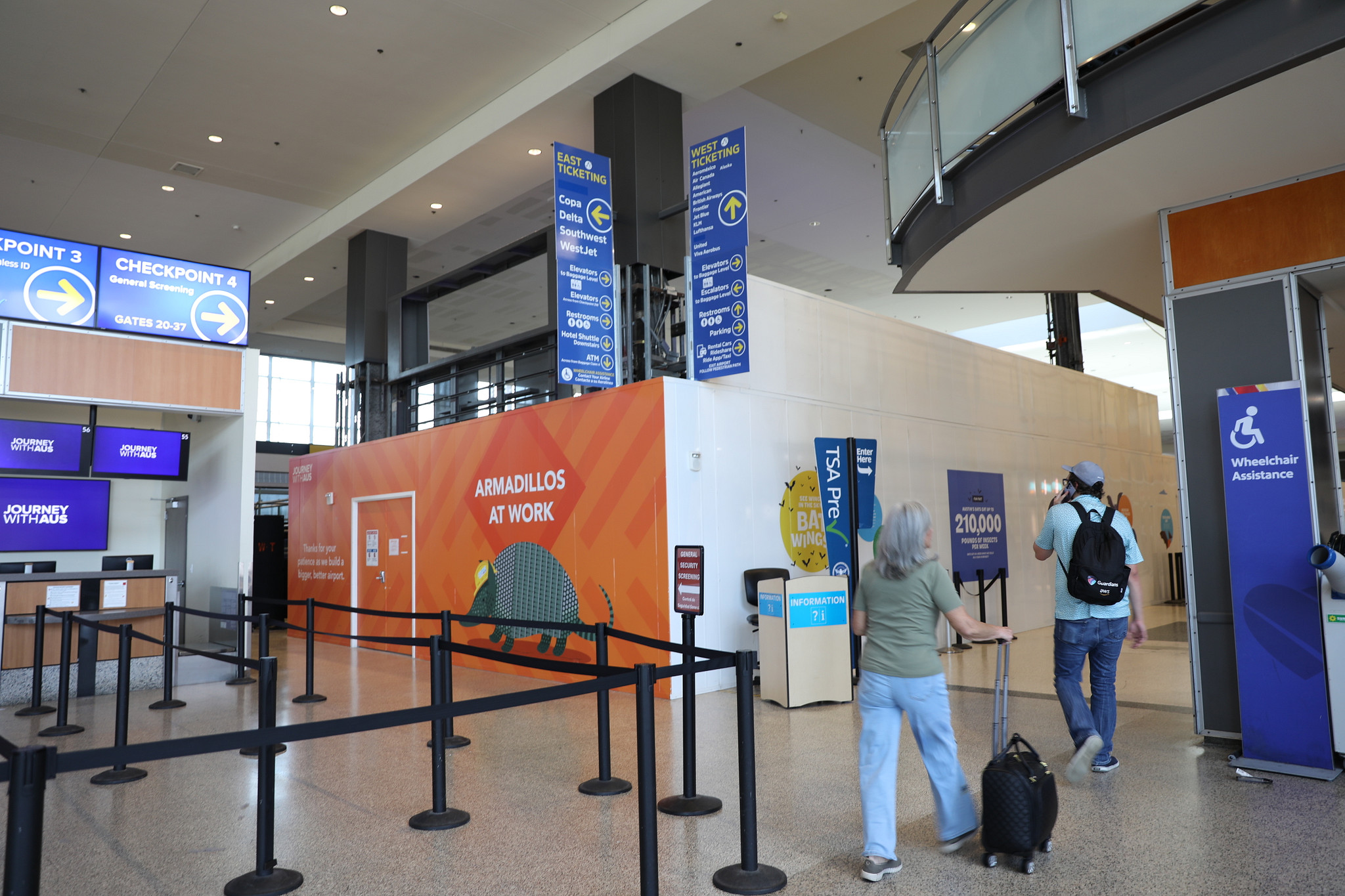 A picture of the outside construction walls of the Atrium Infill Journey With AUS project at Austin-Bergstrom International Airport