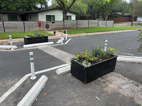 Planter boxes lining bike lanes and sidewalks in Austin