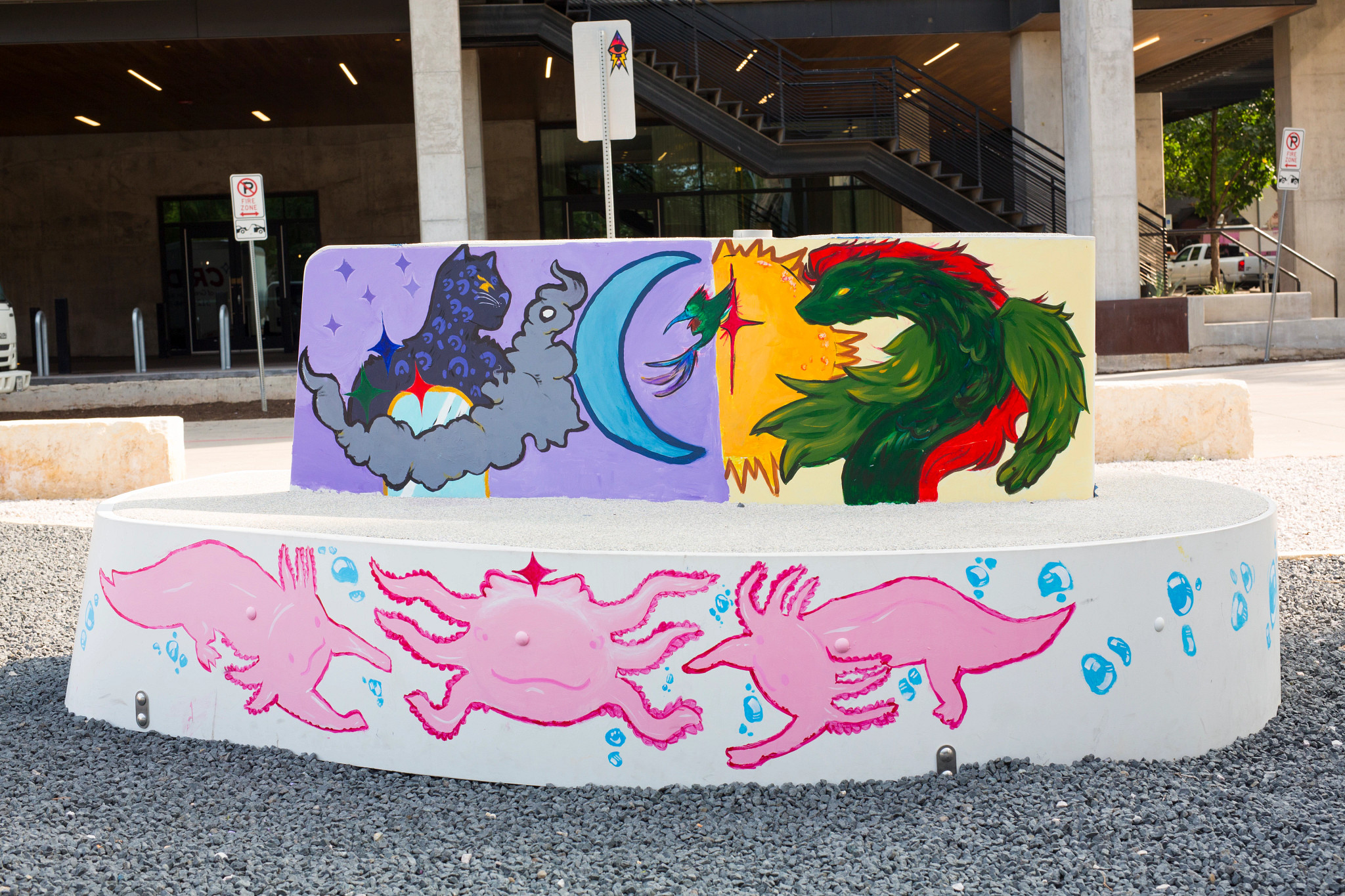 White contemporary outdoor bench with a painting of axolotls, a dragon, and a panther on the surface