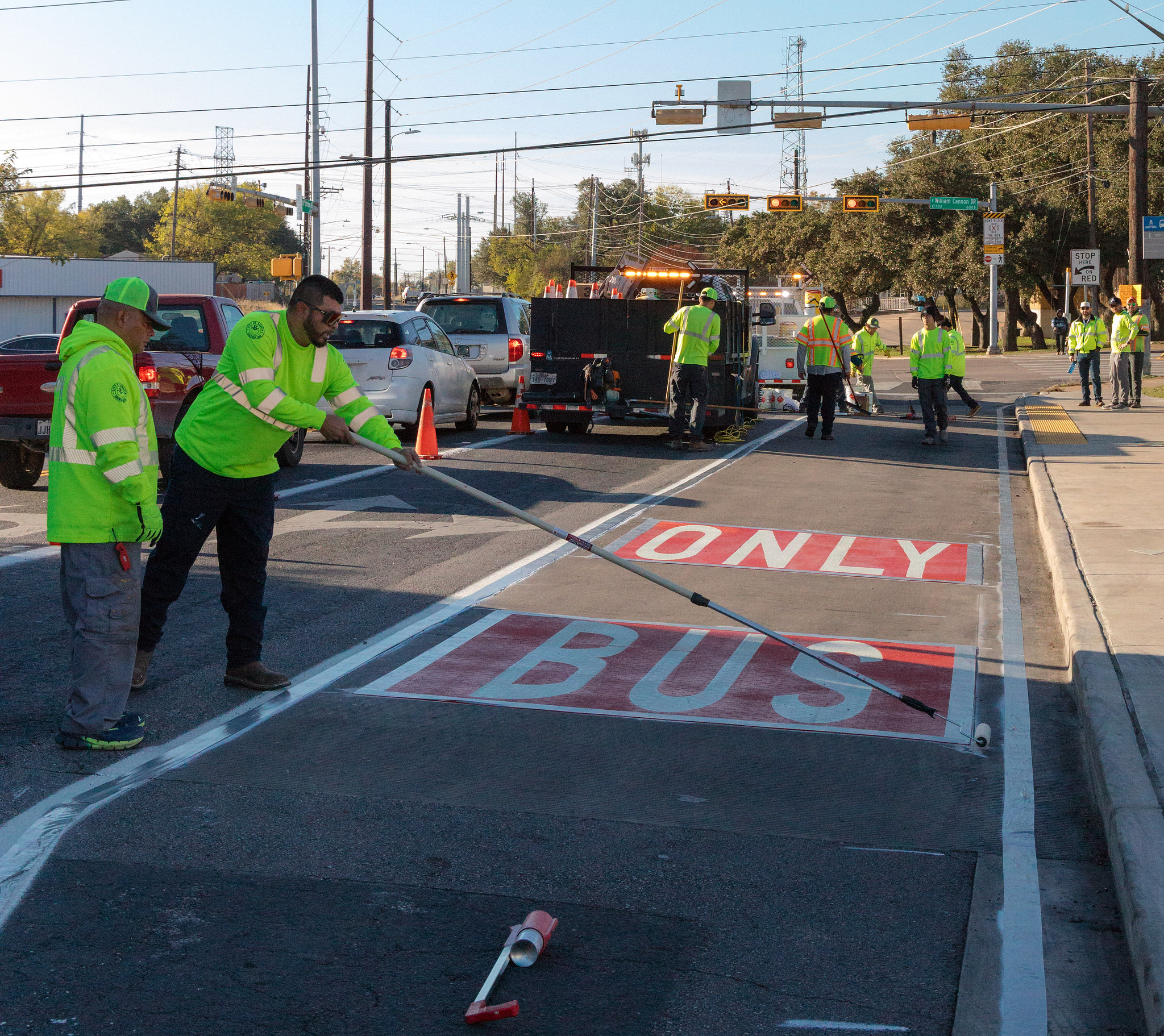 Crews from Austin Transportation and Public Works paint markings for a new Bus Only lane on Bluff Springs Road near William Cannon Drive.