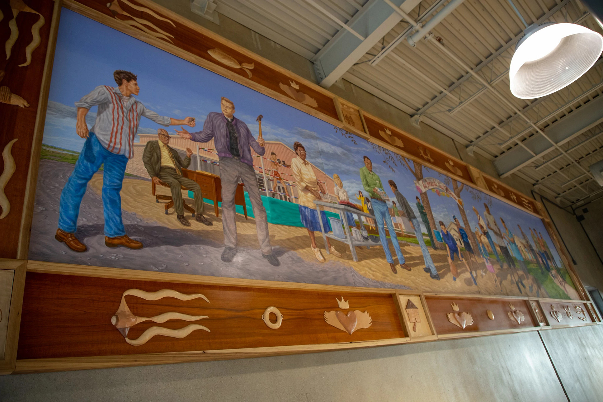 Large mural inside the Montopolis Recreation and Community Center depicting people and scenes from the history of the Montopolis community.