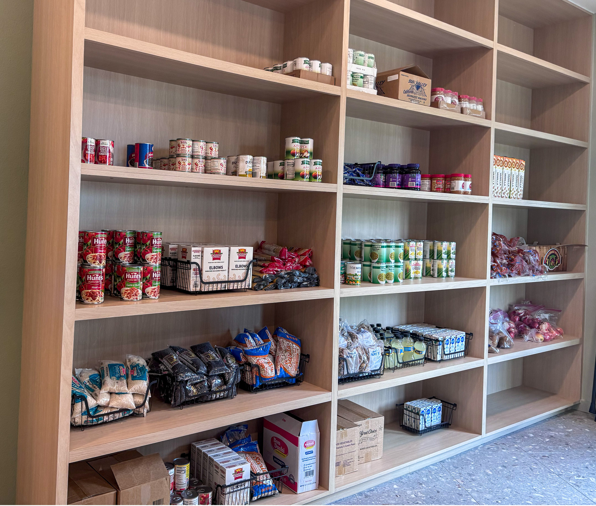 Seabrook Square food pantry with stocked shelves with canned goods, boxed food, and pantry items.