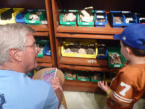 Man with child looking at nature items