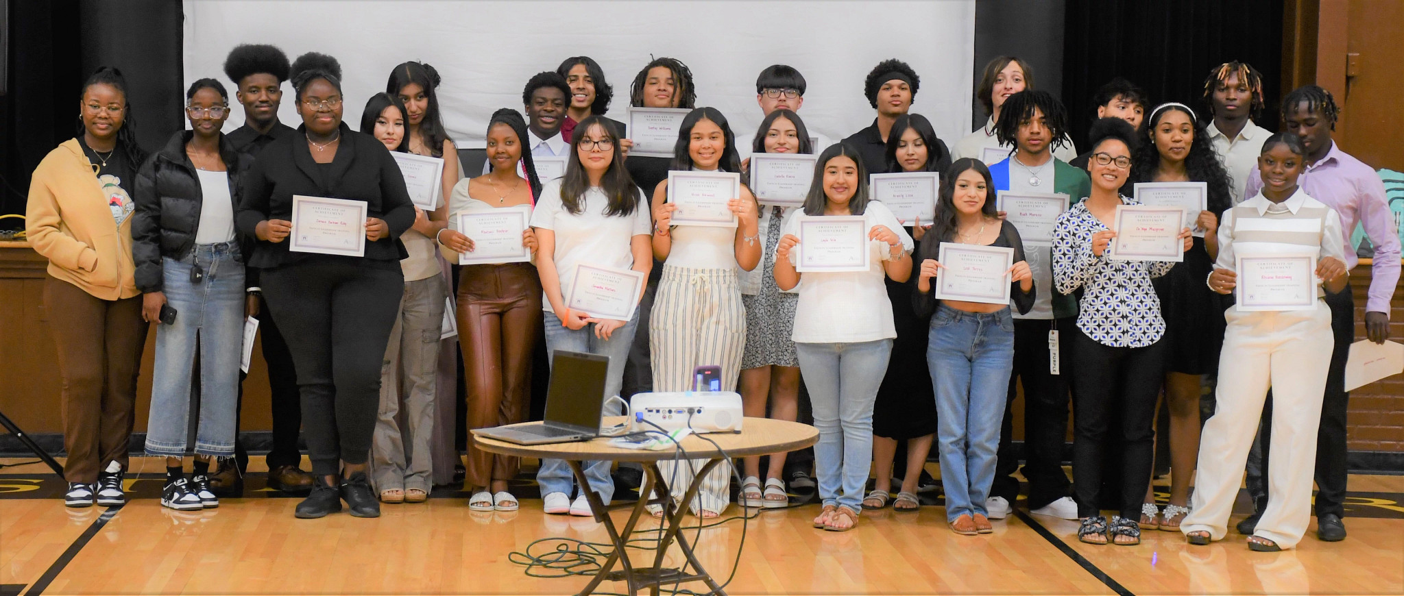 Group of students holding a graduation certificate