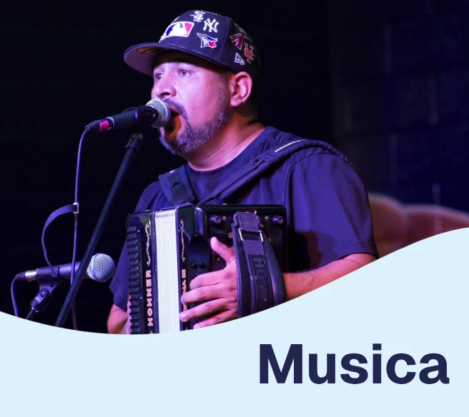 man playing accordion and singing into a microphone
