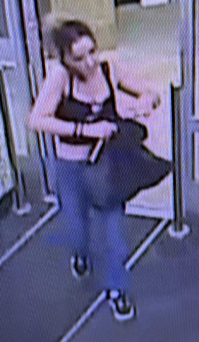 female suspect walking into business