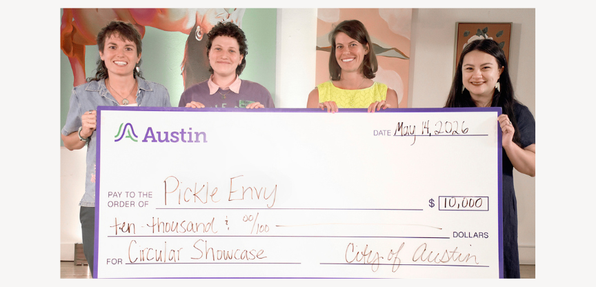 Pickle Envy and City of Austin staff hold giant check