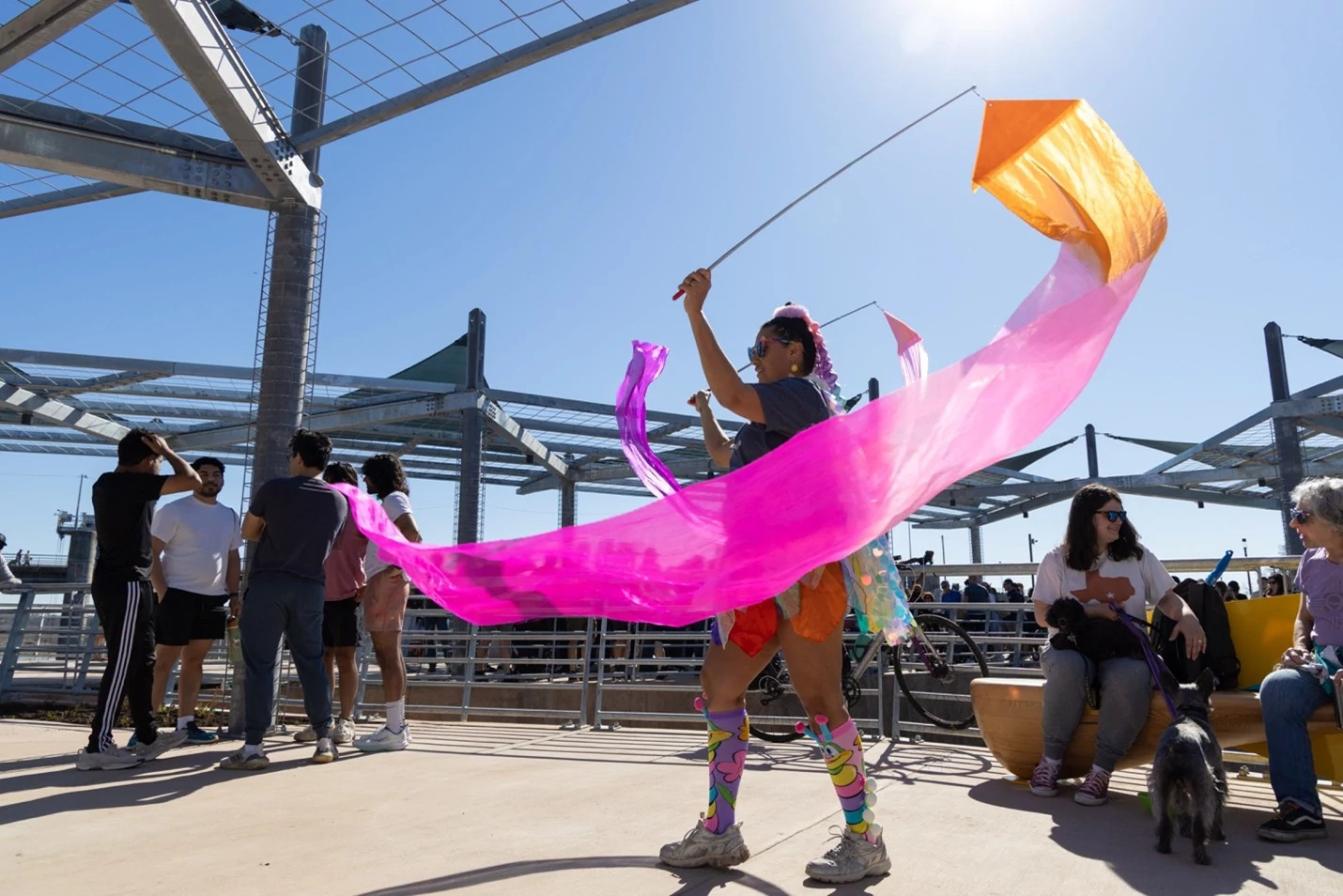 A community member celebrates at the project’s grand opening. A maraca bench can be seen on the right. Photo by Austin Transportation and Public Works.