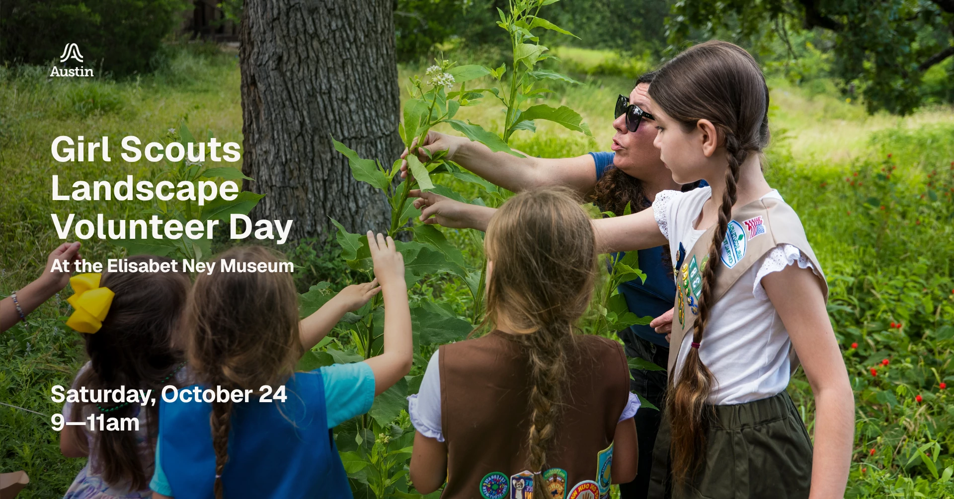 Girl Scouts searching through foliage in a park