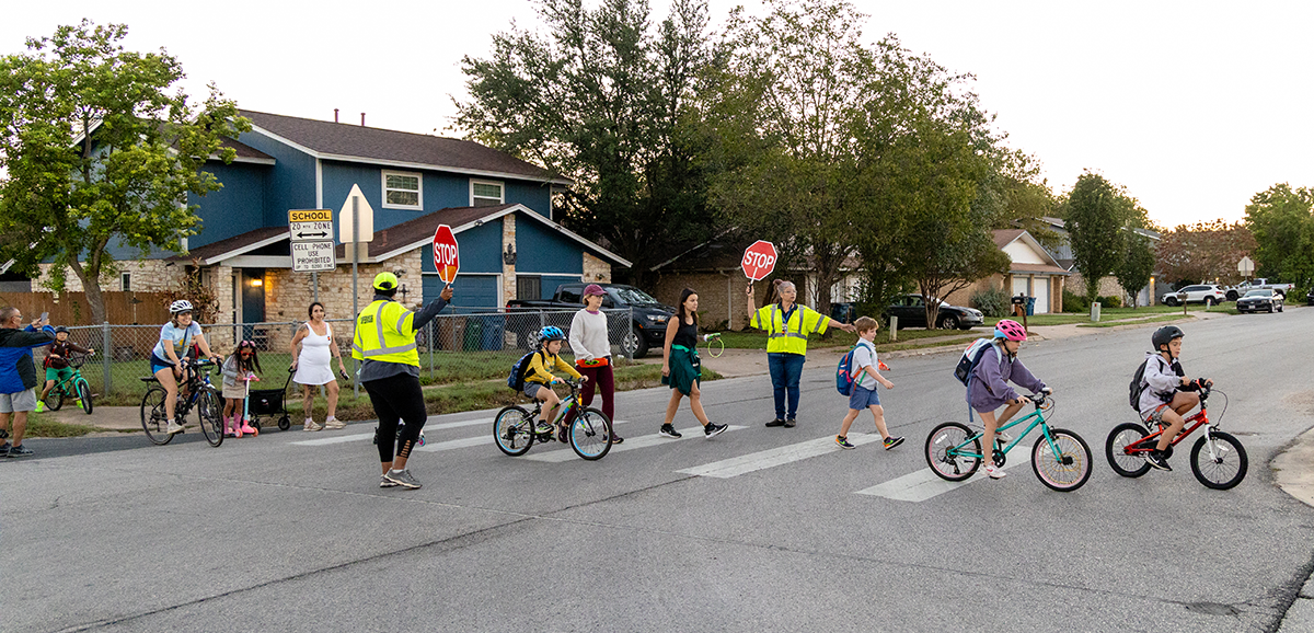Students cross the street on their way to Cunningham Elementary on National Walk and Roll to School Day 2026.
