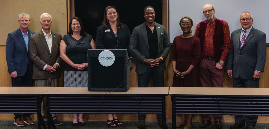 Group photo of regional leaders gathered at Austin City Hall to celebrate the launch of the new CTXGO app.