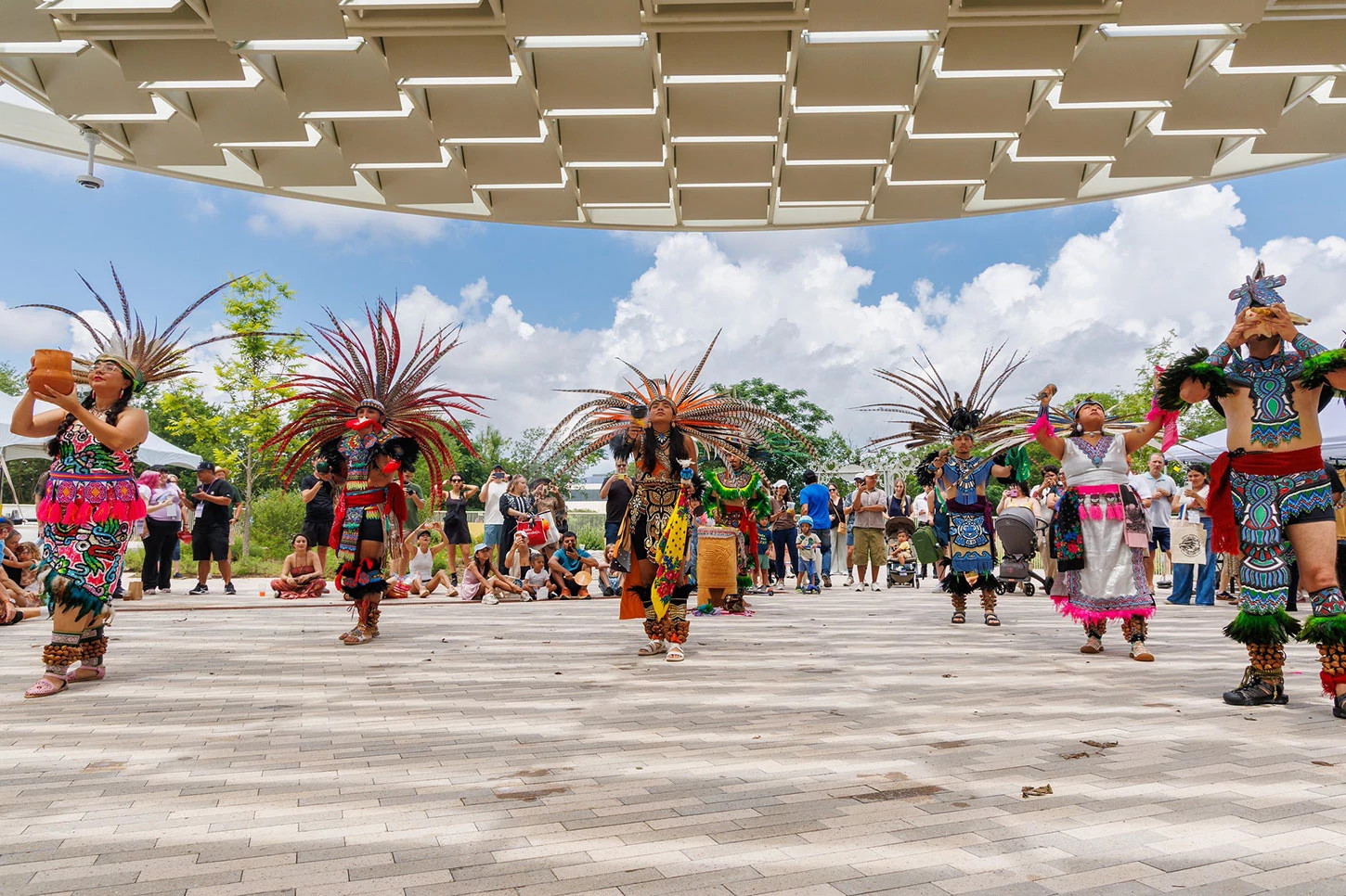people in native costumes dancing under a zocalo