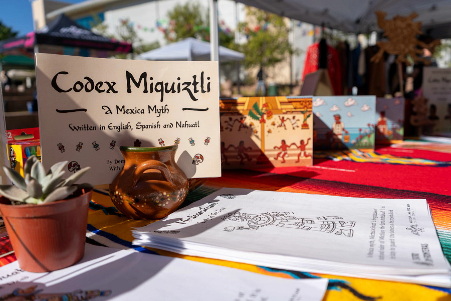 A table with indigenous cultural items and a codex book