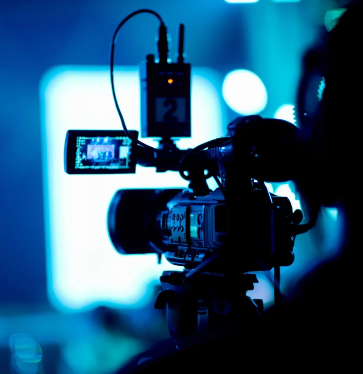 an individual holding a television camera
