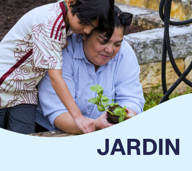 mother and child at a garden holding a plant