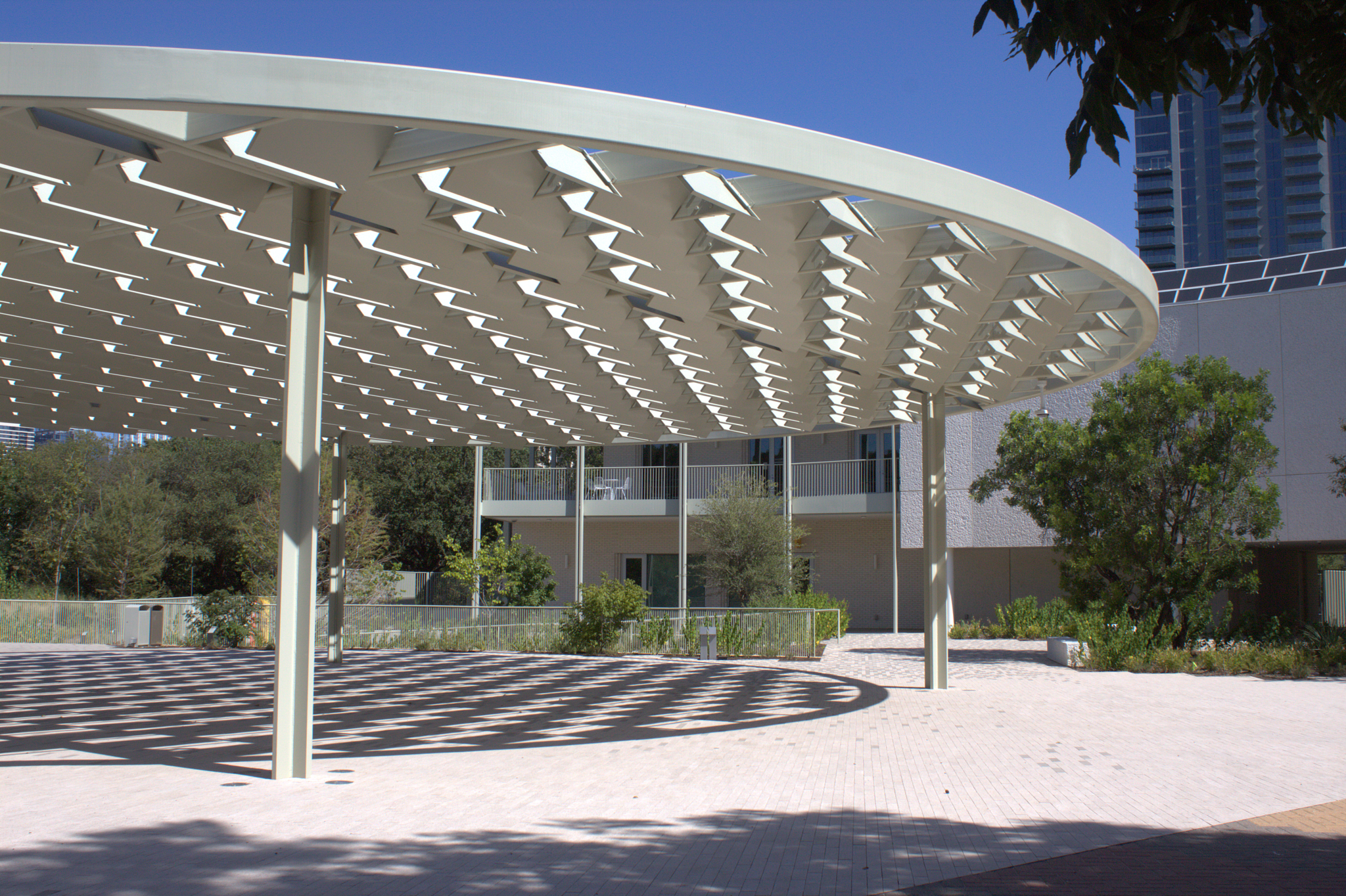 ESBMACC Zocalo - a circular shade structure in the middle of tiled concrete floor on a sunny day