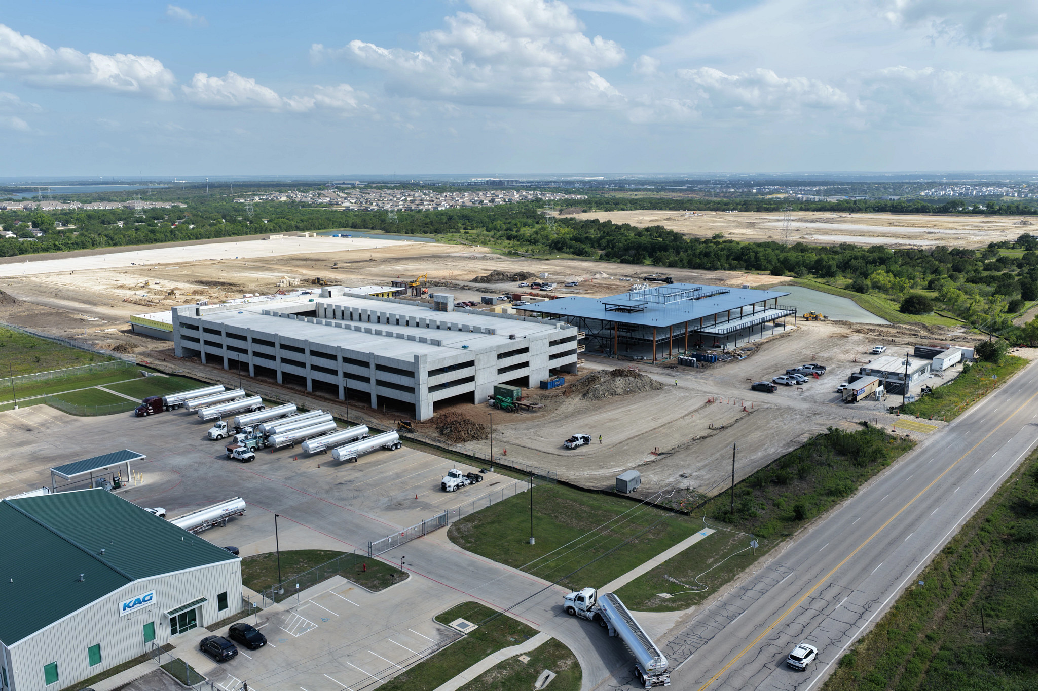 Construction progress on the Northeast Service Center shows parking garage and buildings being erected.