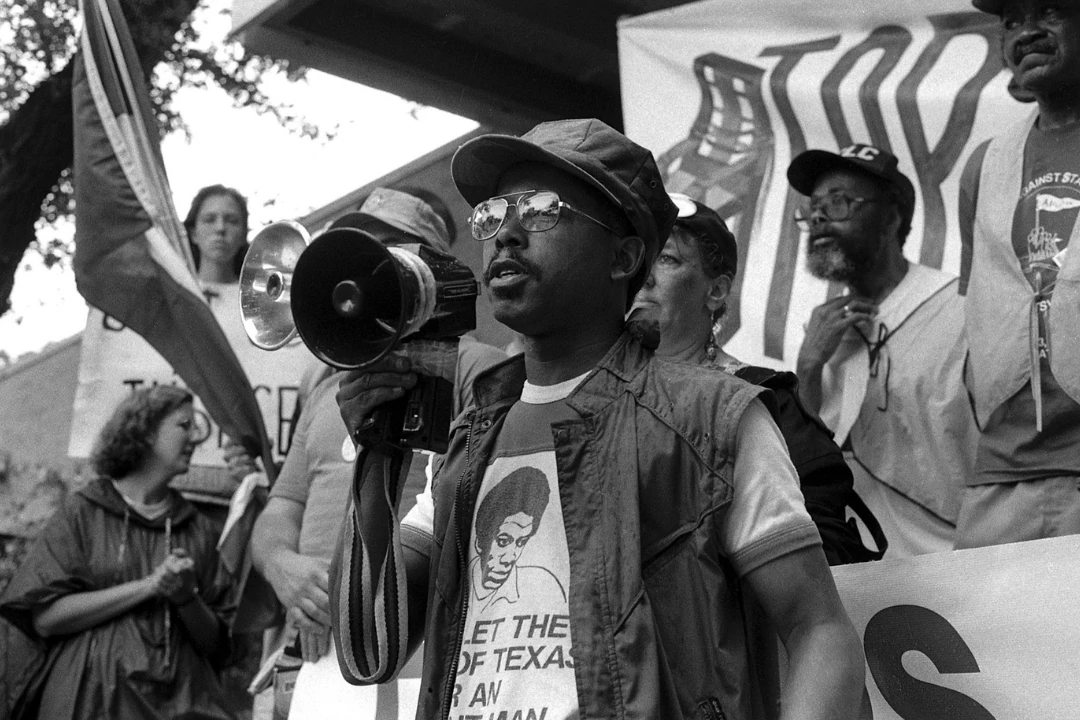image of protesters with the focus on one gentleman speaking into a megaphone 