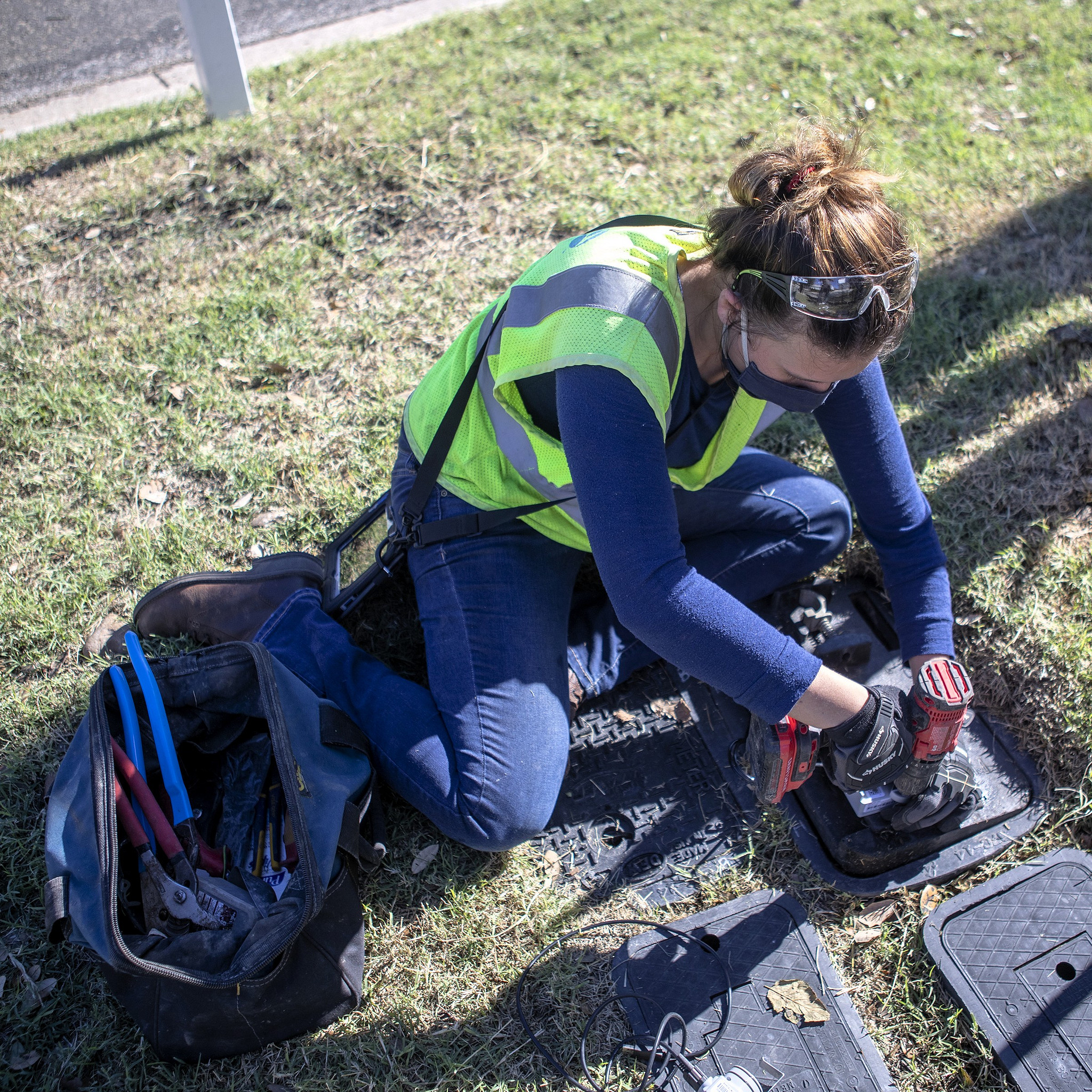 An Austin Water technician installing a smart water meter.