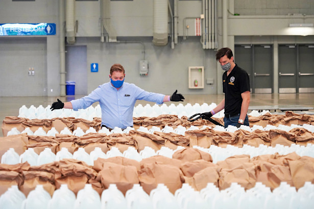 ACCD staff in front of prepared meals for food shelters and food banks