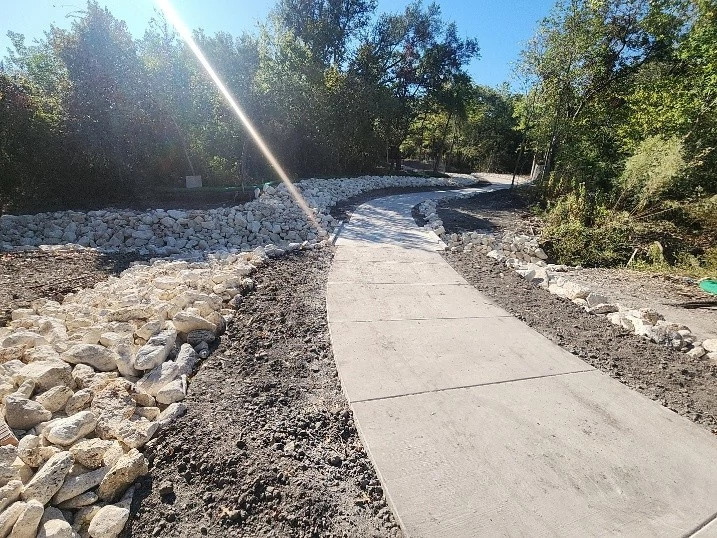 Photo of freshly poured paved sidewalk and bordering landscaping at Ridgeline Nighborhood Park