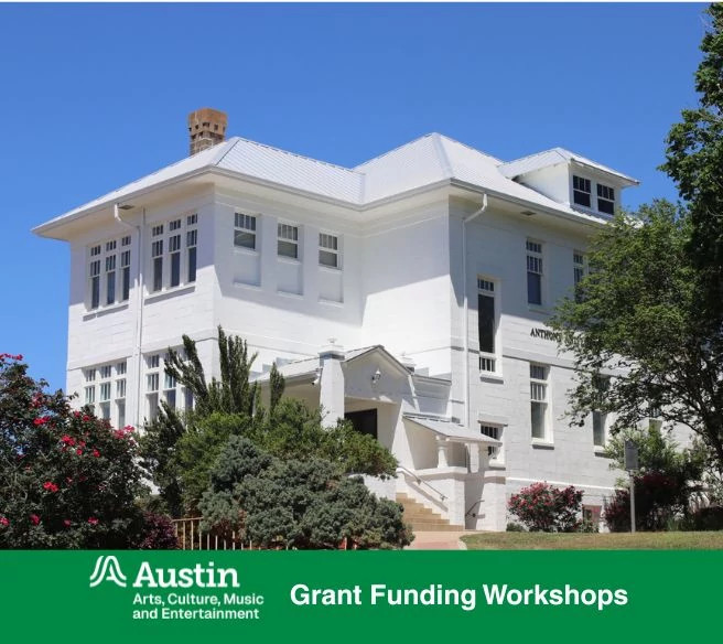 Exterior view of a historic white building with large windows, a metal roof, and surrounding landscaping including shrubs and flowering plants. A banner displays the Austin Arts, Culture, Music and Entertainment logo and Workshop for Heritage Preservation