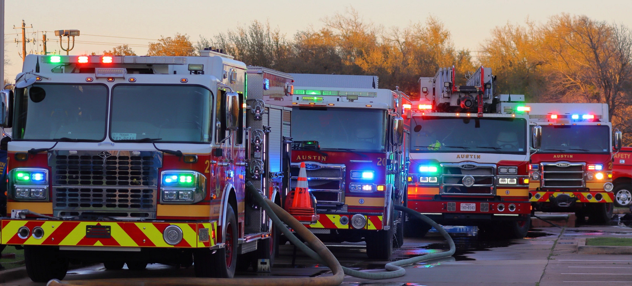Four Fire trucks with lights on 
