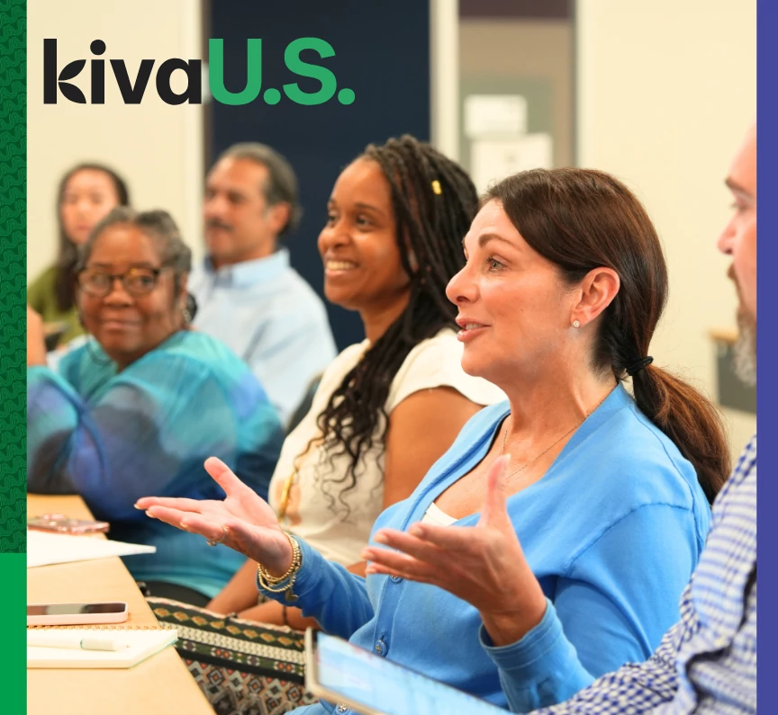 a group of adults smile at a woman as she speaks and gestures with her hands. kiva u.s. logo is in the top left hand corner.