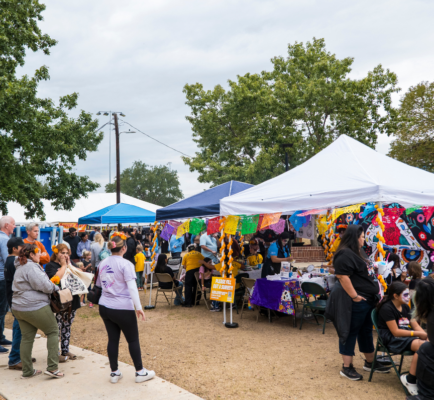 Crowd of people milling about outdoor vendor market