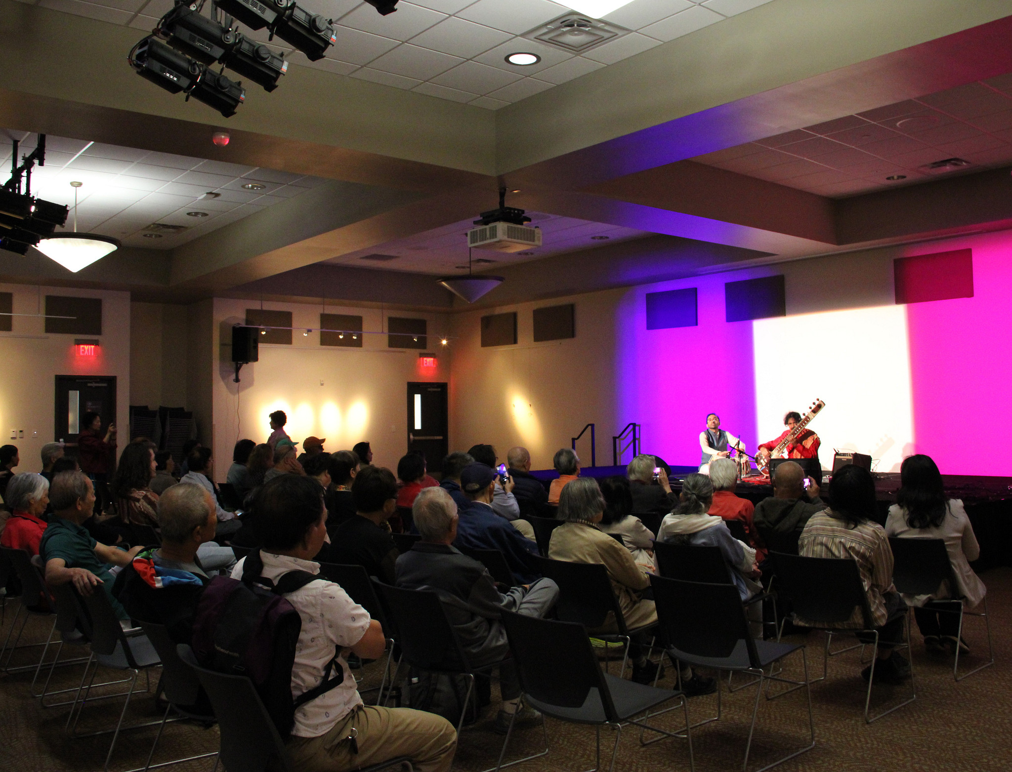 Senior Program participants sitting in the ballroom watching a sitar performance