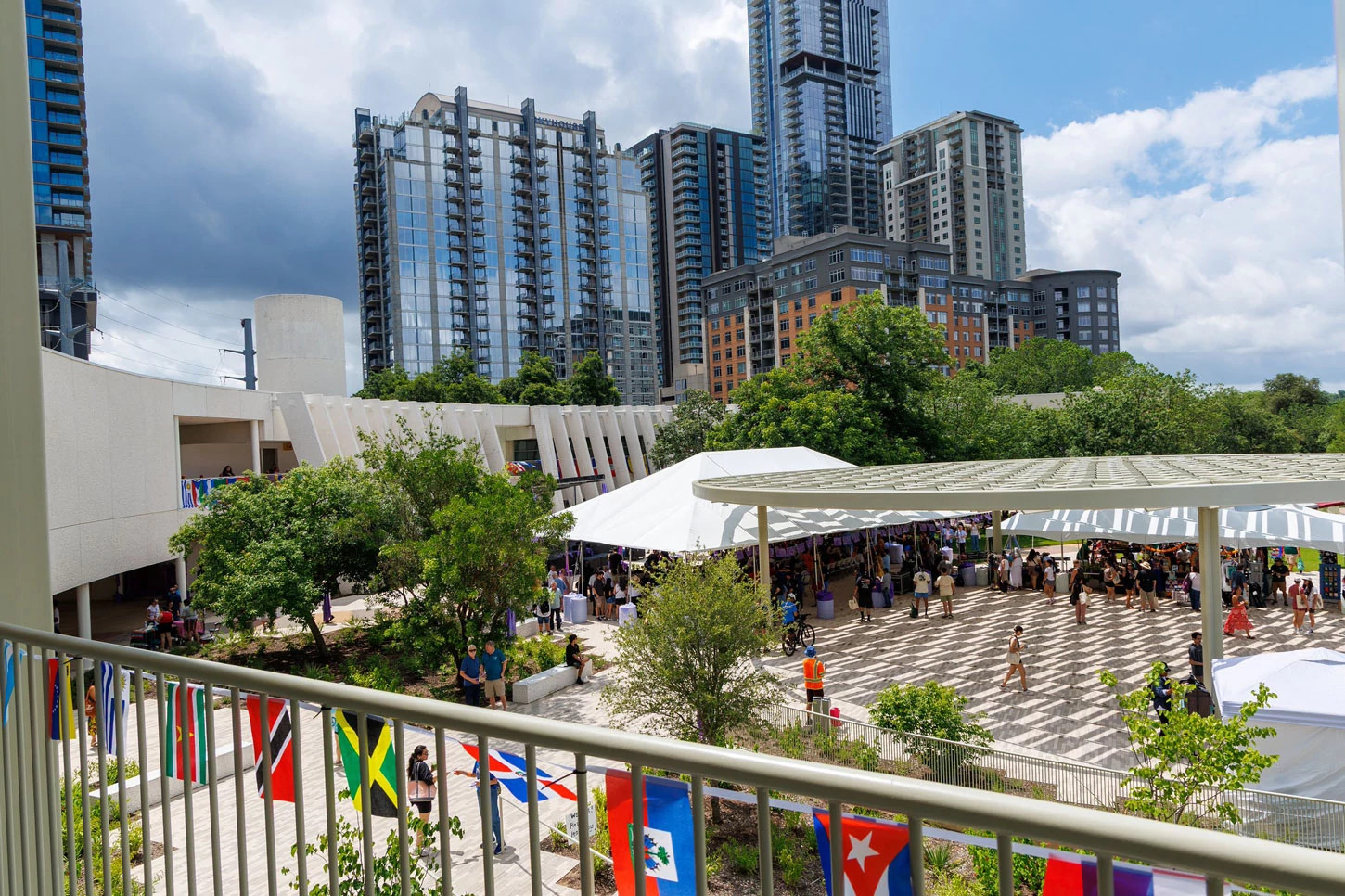People walking outdoors under zocalo and an event tent