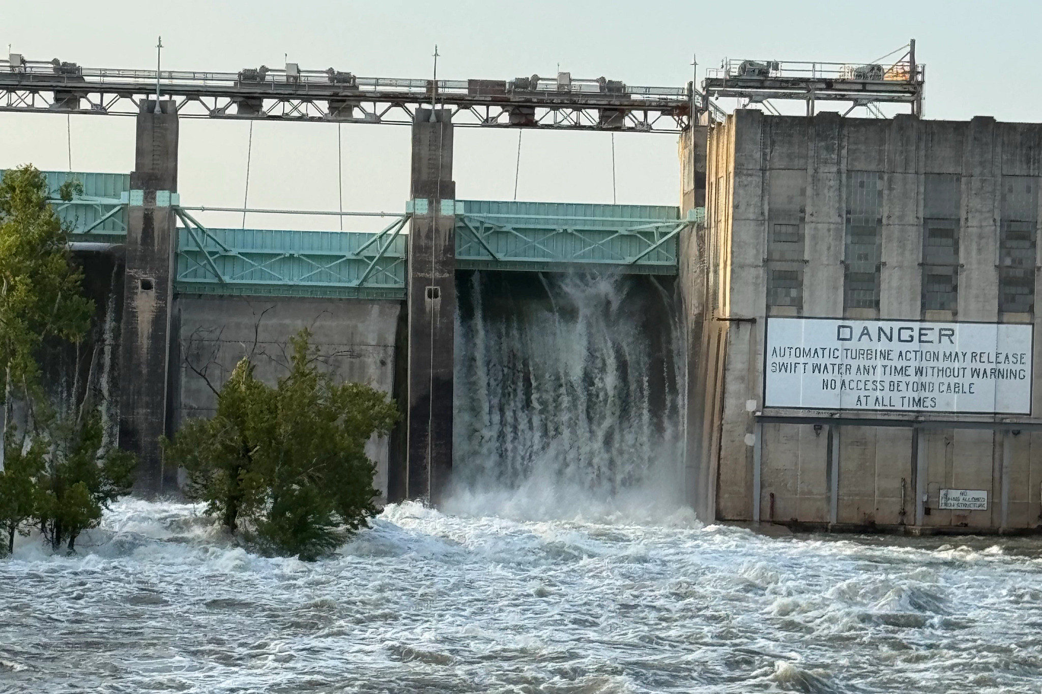 Tom Miller Dam floodgate open with water gushing through