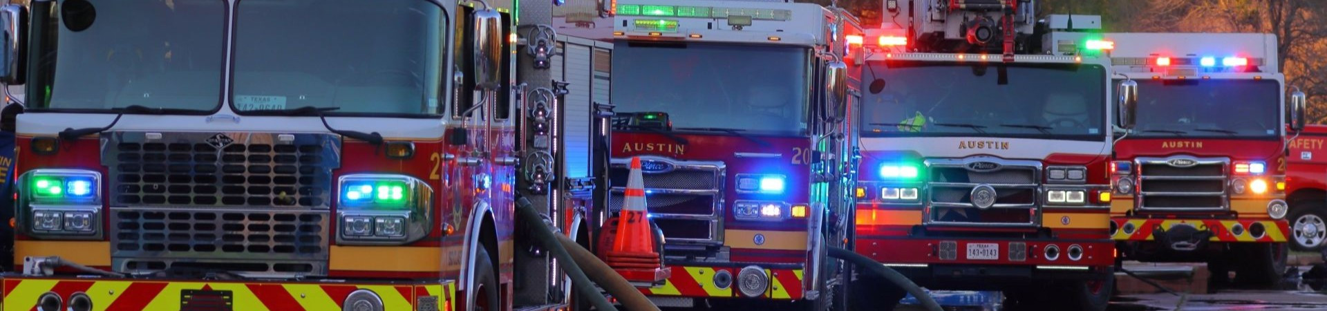 Four Fire trucks with lights on