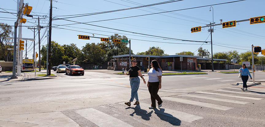 Street view image of people crossing on the crosswalk at the intersection of South First Steet and Radam Lane.