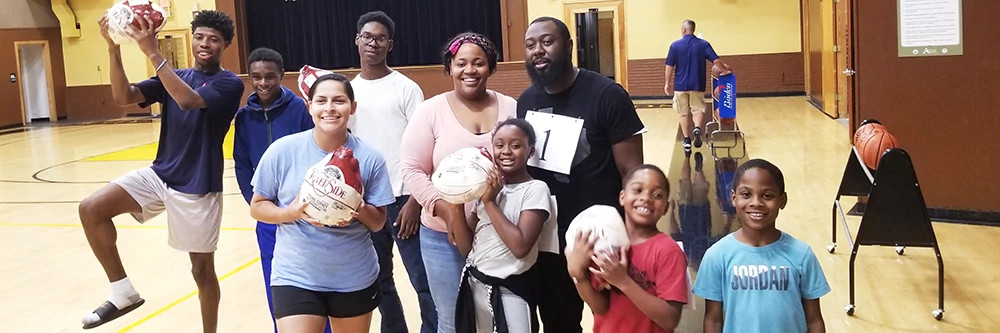 Group of people celebrating winning frozen turkeys