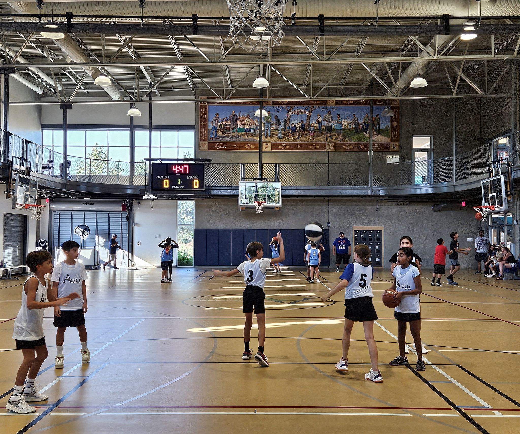 Children play basketball in a gym