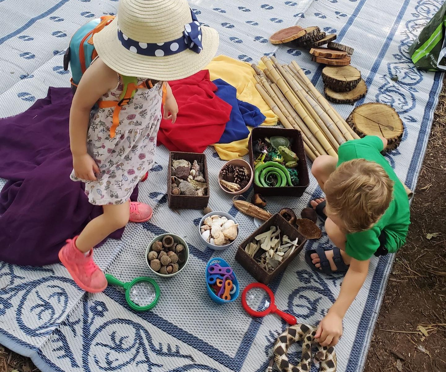 Children play with a nature play loose parts kit