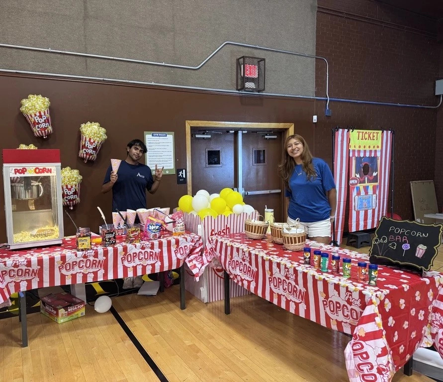 Staff smiling behind concession table for festival
